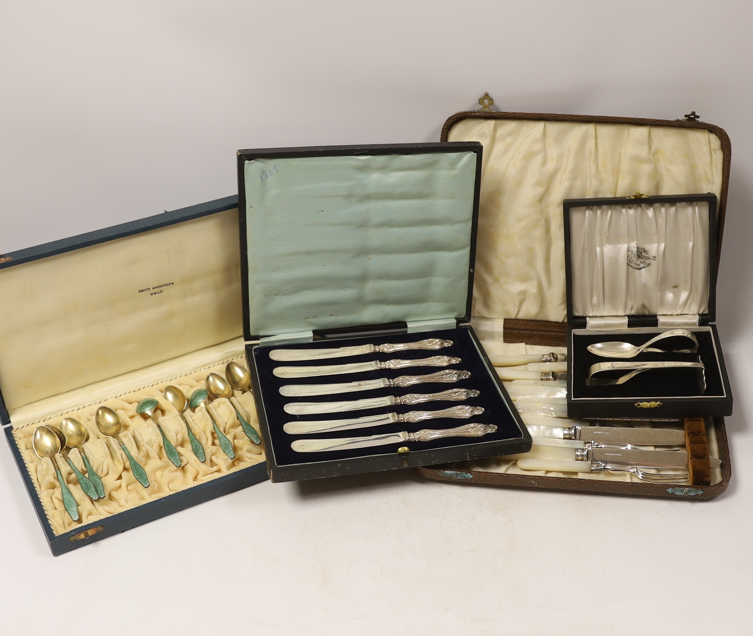 Four assorted cased cutlery sets including a set of twelve Norwegian gilt 925 and guilloche enamel coffee spoons.